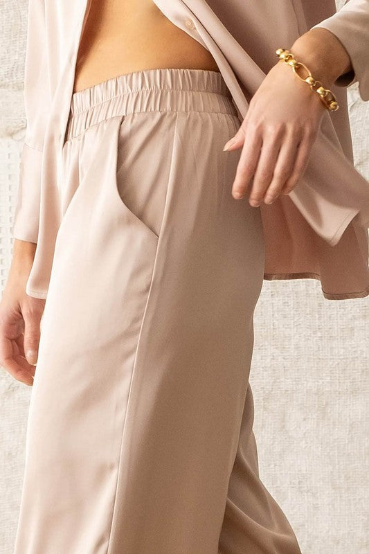 model is wearing Light Taupe Satin Bell Bottom Pants with chunky bracelet and matching top 