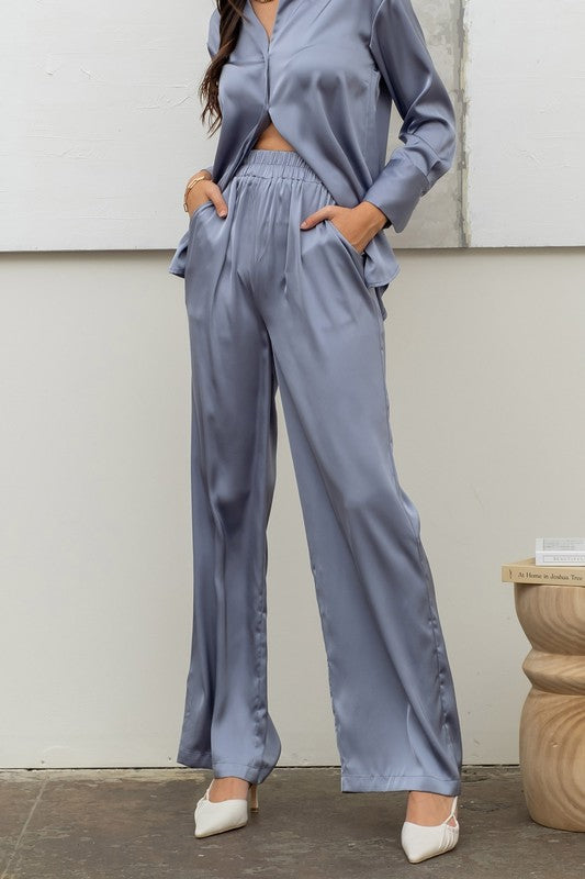 model wearing Dusty Blue Satin Bell Bottom Pants  with matching top 