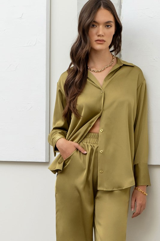 model is wearing Light Olive Satin Button Up Top with matching pants and chunky gold jewelry 