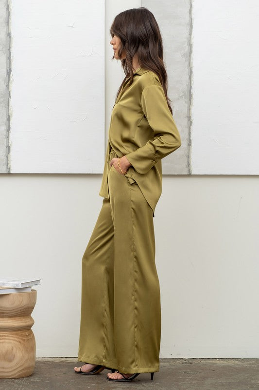 side of the model wearing Light Olive Satin Button Up Top with matching pants and black heels 