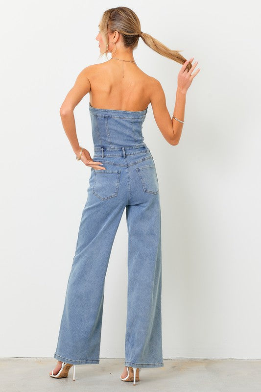 STYLED BY ALX COUTURE MIAMI BOUTIQUE Model is wearing Light Denim Off Shoulder Jumpsuit with high heels . Back view of the jumpsuit