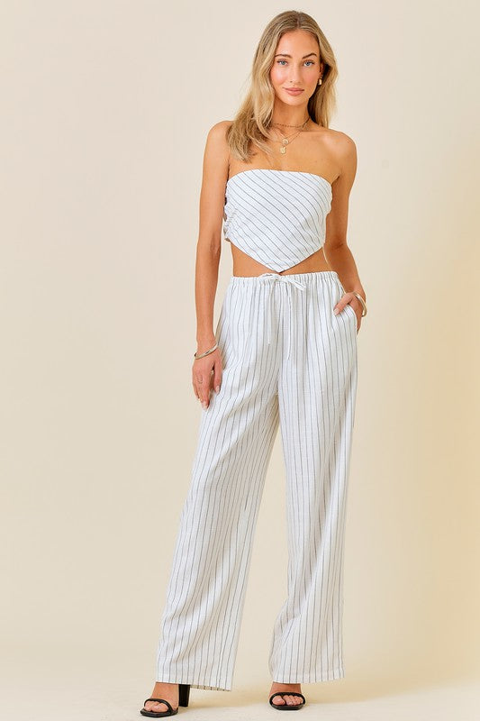 Styled by ALX COUTURE Miami boutique Model is wearing White Striped Set Linen Wide-Leg Pants with a Crop Top with black heels and jewelry 