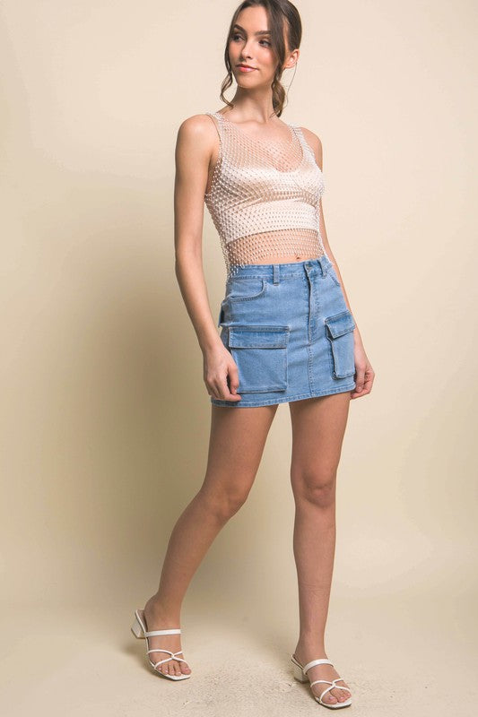 model is wearing Light Blue Mini Cargo Denim Skirt with beige mesh top and white sandals