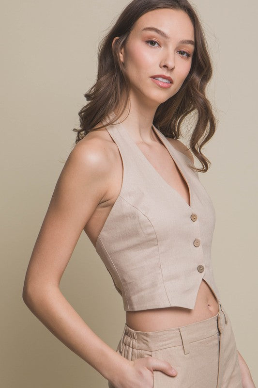 model is wearing Khaki Linen Cropped Vest and matching pants. Side view 
