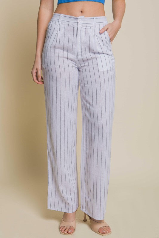 model is wearing White Linen Stripe Flannel Pants  with a blue top and beige heels sandals 