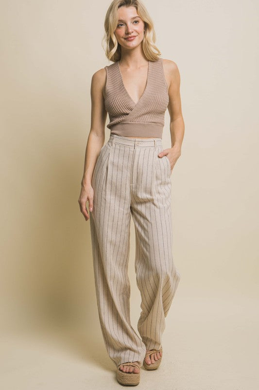 model is wearing Khaki Linen Stripe Flannel Pants  with a brown top and beige wedges 