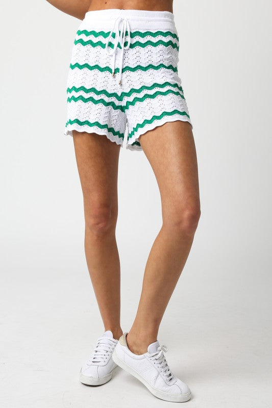model is wearing White Green Megan Shorts  with white sneakers