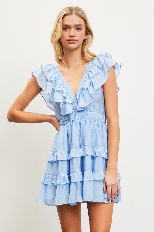 model is wearing Light Blue Ruffle Tiered Dress with a gold necklace 