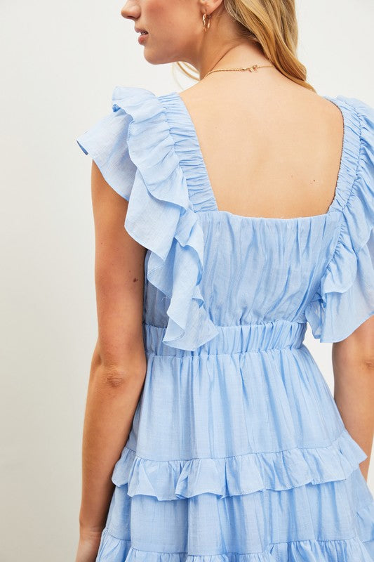 model is wearing Light Blue Ruffle Tiered Dress, close up view of the back 