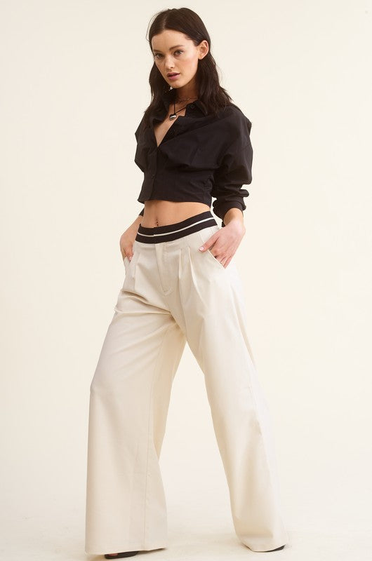 model is wearing Black Giselle Shirt with white wide leg pants