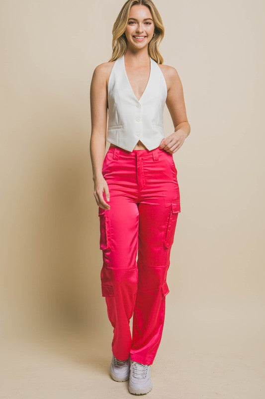 model wearing White V-neck Sleeveless Vest  with pink cargo pants and white sneakers