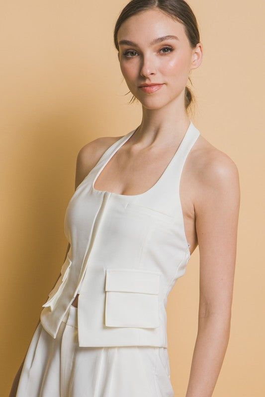 model is wearing Black Halter Zip- Up Vest with matching white pants