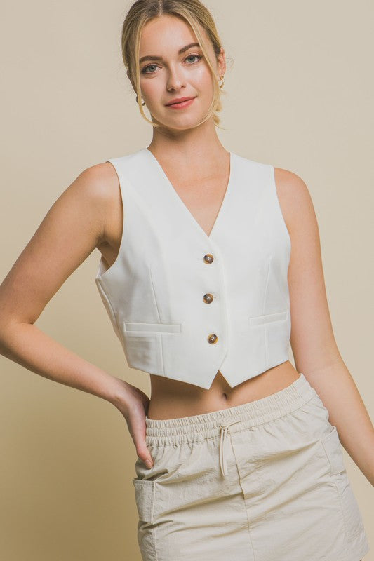 model is wearing White Cropped Blazer Vest and beige skirt