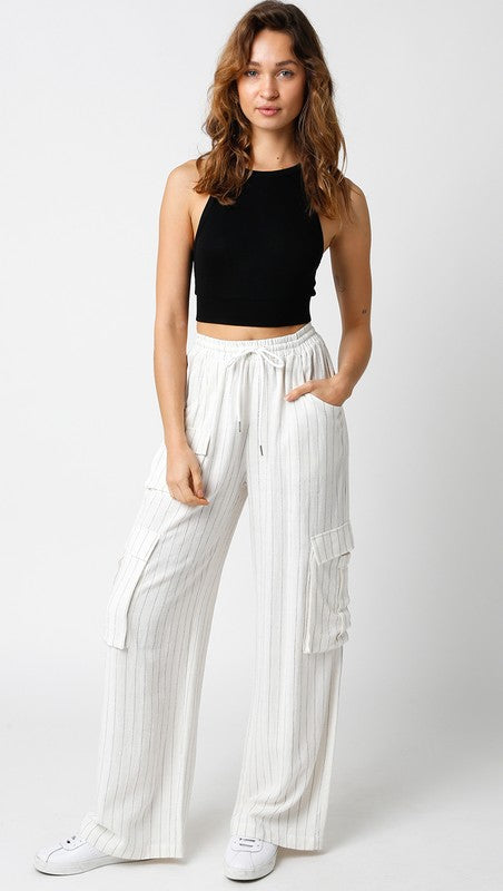 model is wearing Ivory Black Melanie Pants with black top and white sneakers