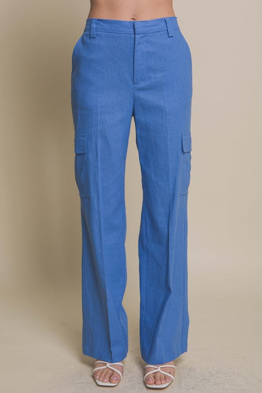Model is wearing Blue Linen Cargo Pants and white sandals 
