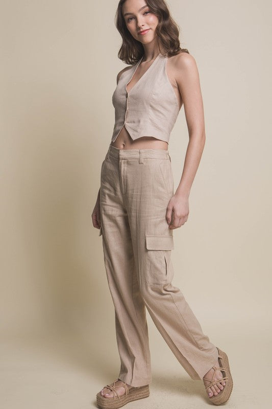 Model is wearing Khaki Linen Cargo Pants and beige wedges with matching vest 