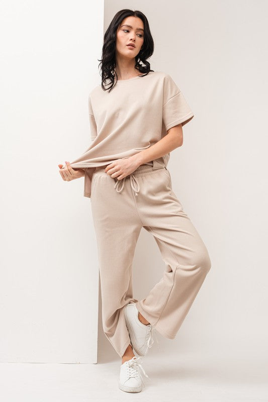 model is wearing Taupe Thick Travel Pant Set and white sneakers 