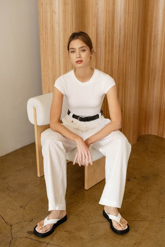 model wearing White Round Neck Bodysuit with white pants and white sandals 