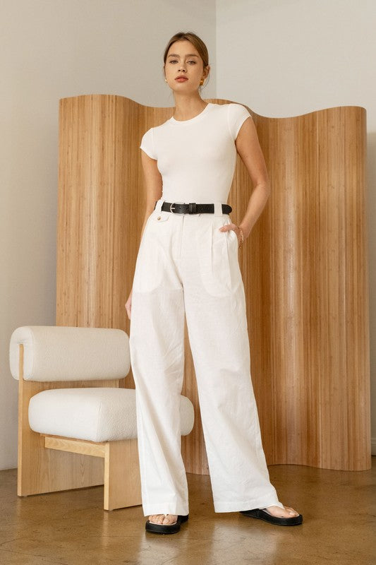 White Round Neck Bodysuit with white trousers black belt and white sandals