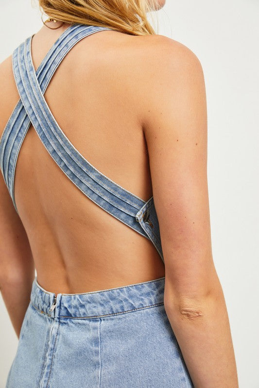 model is wearing Washed Denim Open Back Romper, close up view of the back 