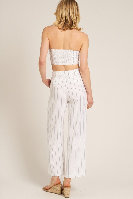 back of the model is wearing Cream Black Striped Tube Pants Set and wedges 