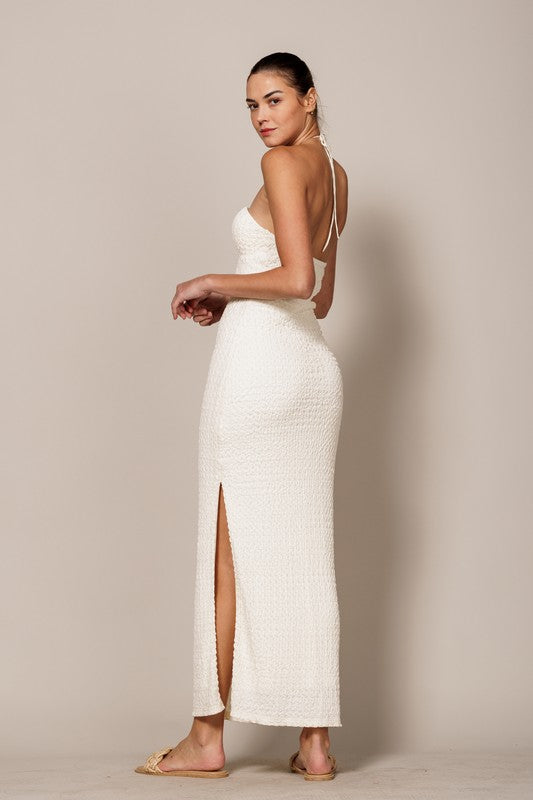back of the model wearing Cream Textured Halter Maxi Dress 