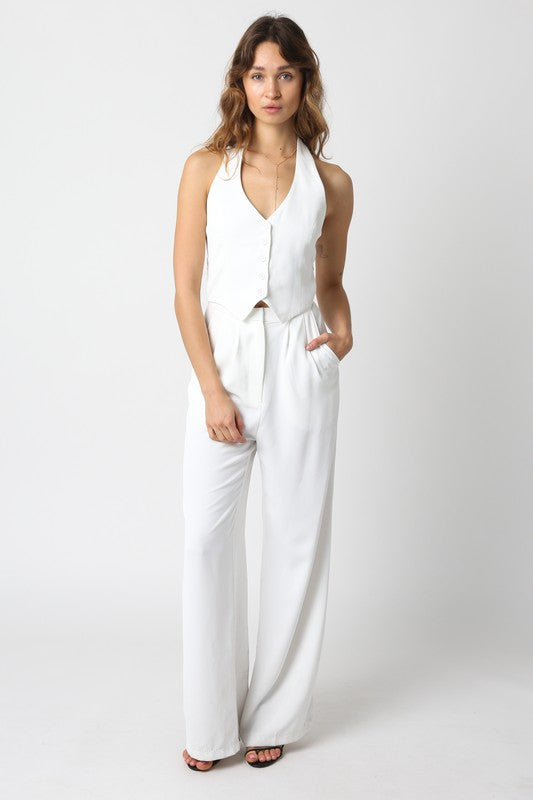 model is wearing White Courtney Jumpsuit  and black heels 