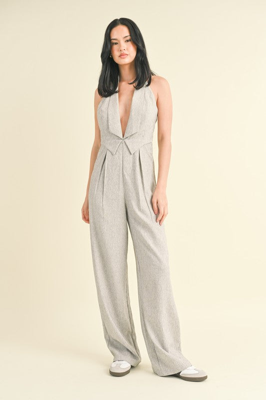 model is wearing Grey Tailored Vest Jumpsuit and white sneakers 