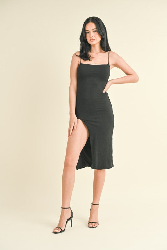 model is wearing Black High Slit Midi Dress and black heels 