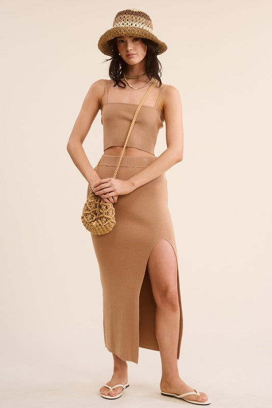 model wearing Camel Haddy Skirt Set  with a striped crochet hat and shoulder bag with white sandals
