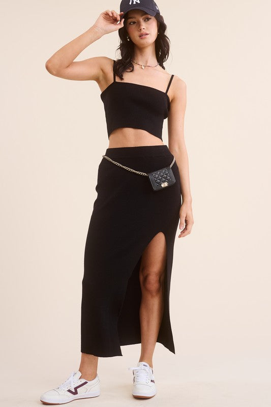 model is wearing Black Haddy Skirt Set with a black baseball cap, a chic fanny bag and white sneakers