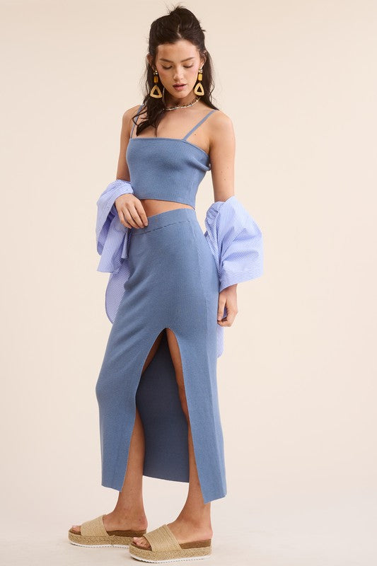 model is wearing Steel Blue Haddy Skirt Set with a blue shirt and beige slide sandals