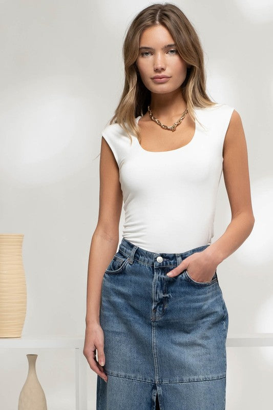 model is wearing White Reversible Sleeveless Crop Top with dark denim skirt