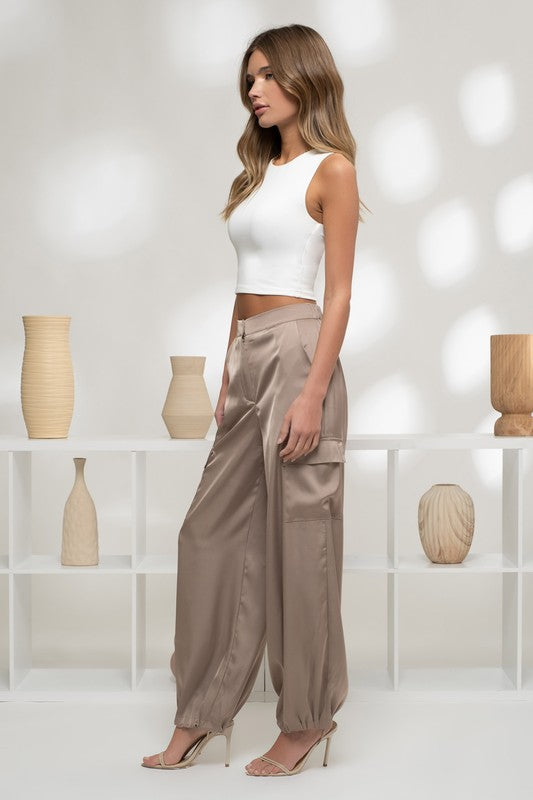 model is wearing with white crop top and gold heels 