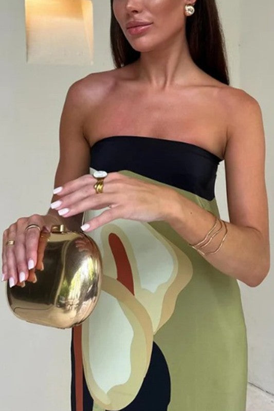 Green Sleeveless Plant Print Maxi Dress with gold clutch bag and gold jewelry 