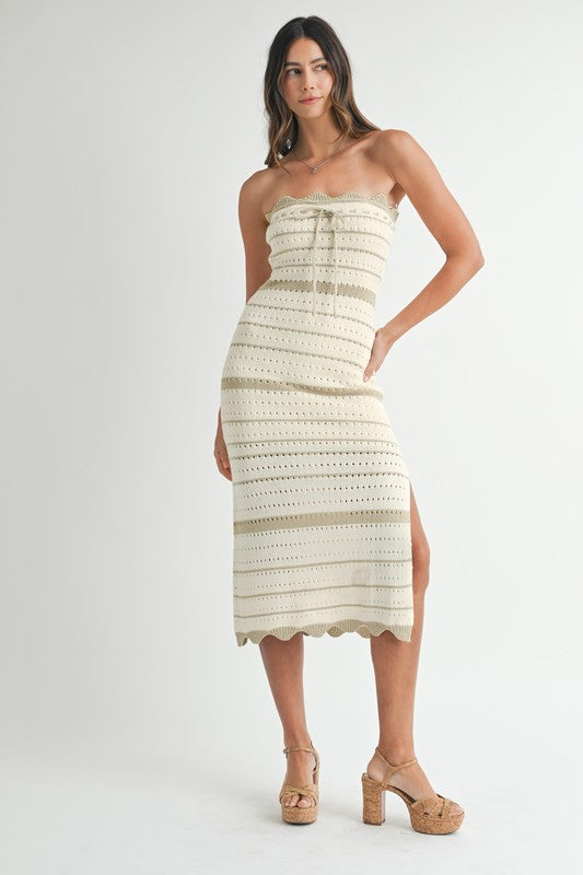 Front view of the model in the strapless crochet midi dress with a drawstring bust and subtle horizontal stripe detailing.