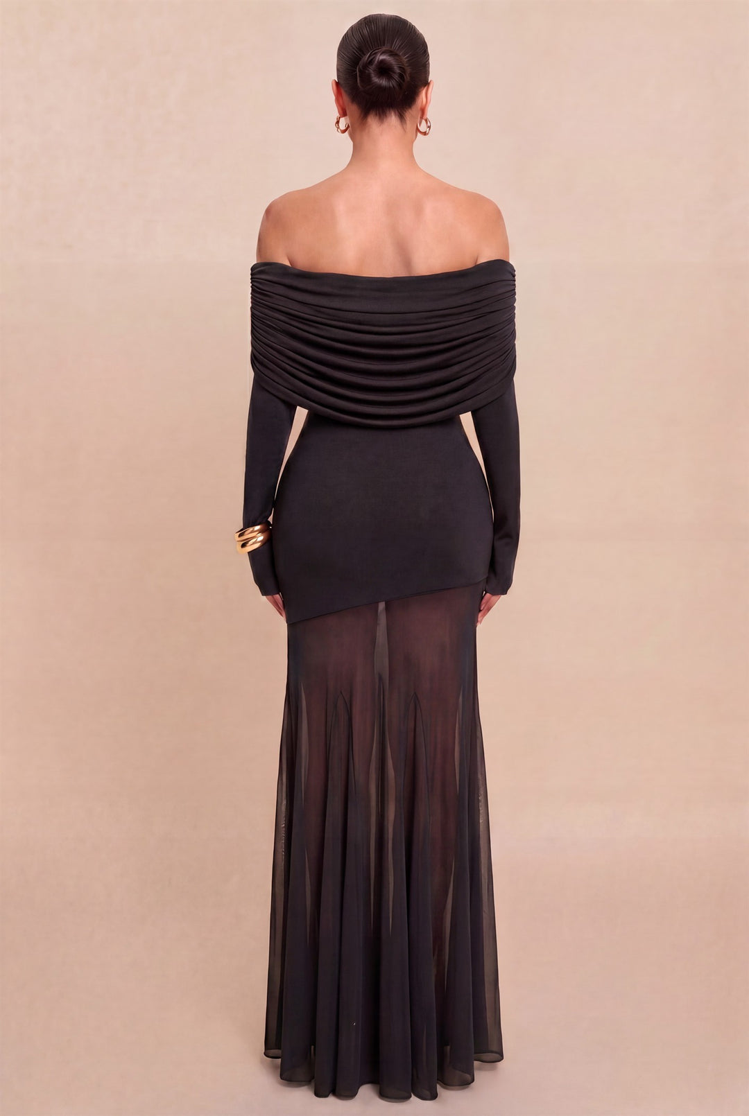 Back view of Luxxel black gown showing the ruched off-shoulder neckline and sheer mesh hem