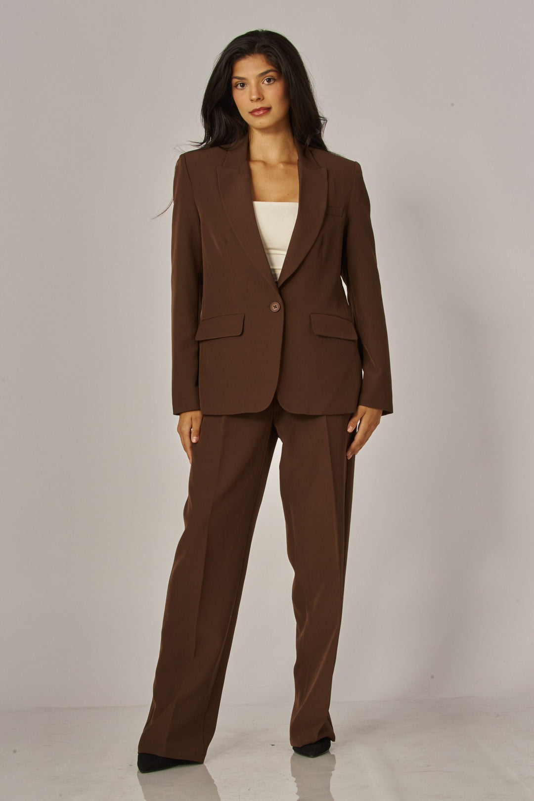 Full-length view of the espresso brown blazer with matching brown trousers and heels, a fall suit outfit