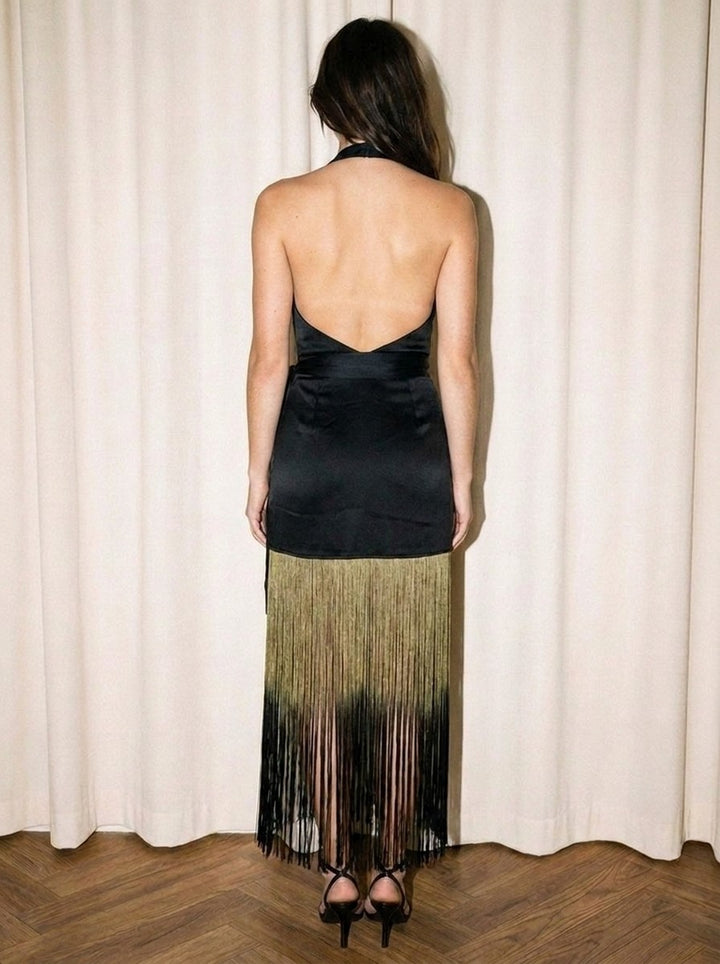 Back view of the black ombre fringe halter dress showing the open halter back and sweeping fringe skirt
