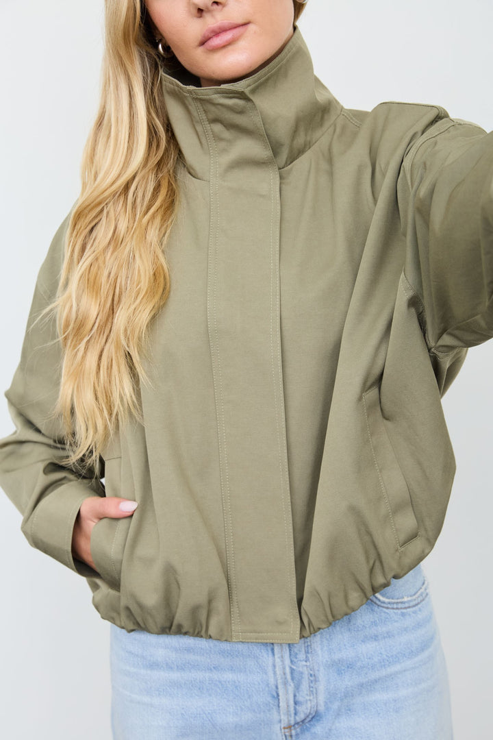Close-up of the olive mock neck zip jacket&