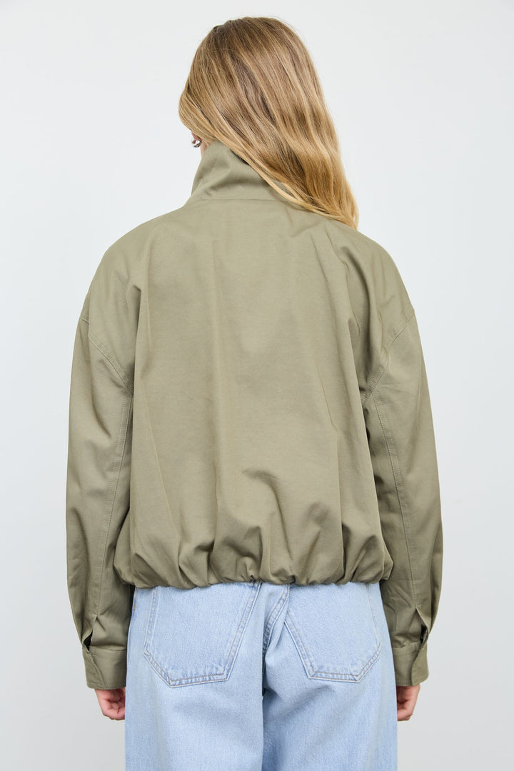 Back view of the olive green mock neck zip jacket showing the funnel collar and relaxed fit