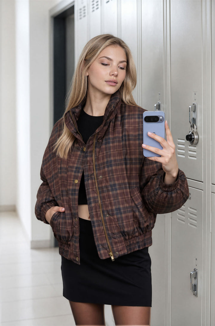 Three-quarter view of the brown plaid cropped puffer jacket with funnel collar, a Thanksgiving weekend look