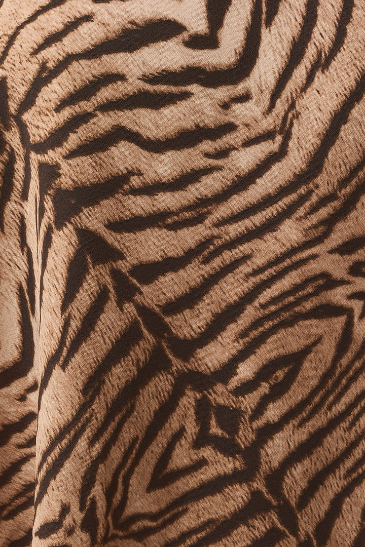 Close-up of the taupe and brown tiger print woven fabric of the halter top