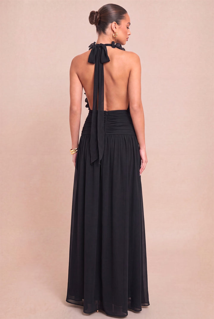 Back view of Luxxel black chiffon maxi dress showing halter bow and ruched waist