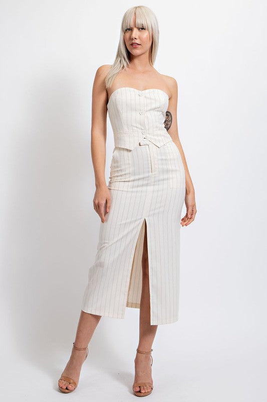 model is wearing Ivory Pinstripe Strapless Crop Top with matching skirt  and beige heels 