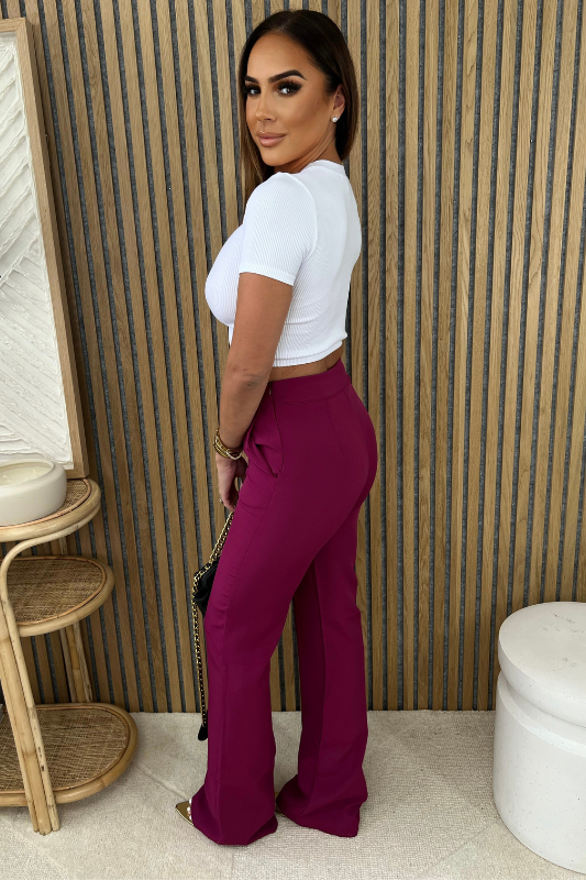 back of Magenta Flared Dress Pant with white basic short sleeve ribbed crew neck crop top. 