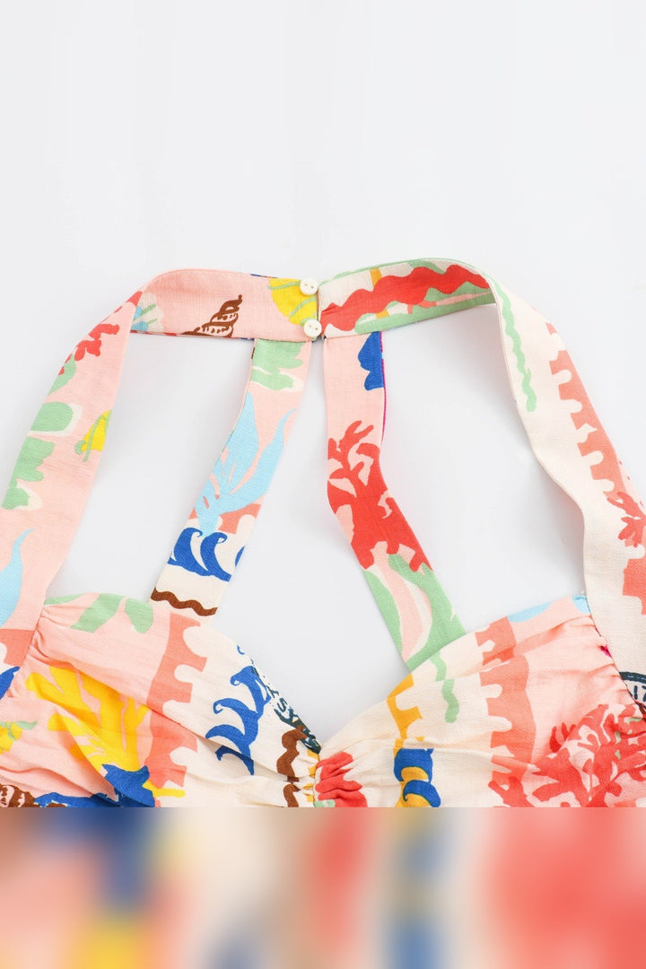 Button-front detail on a printed pleated midi skirt