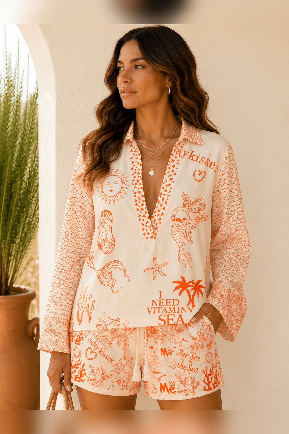 Orange woven two piece set with black and white mermaid print