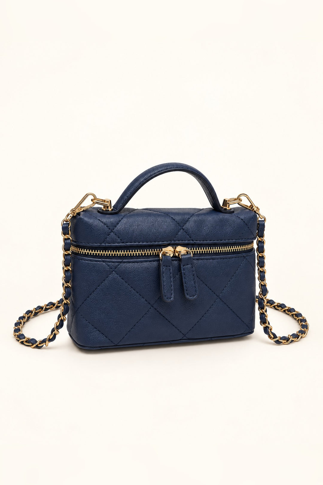 Navy quilted crossbody at an angle showing its compact structured shape