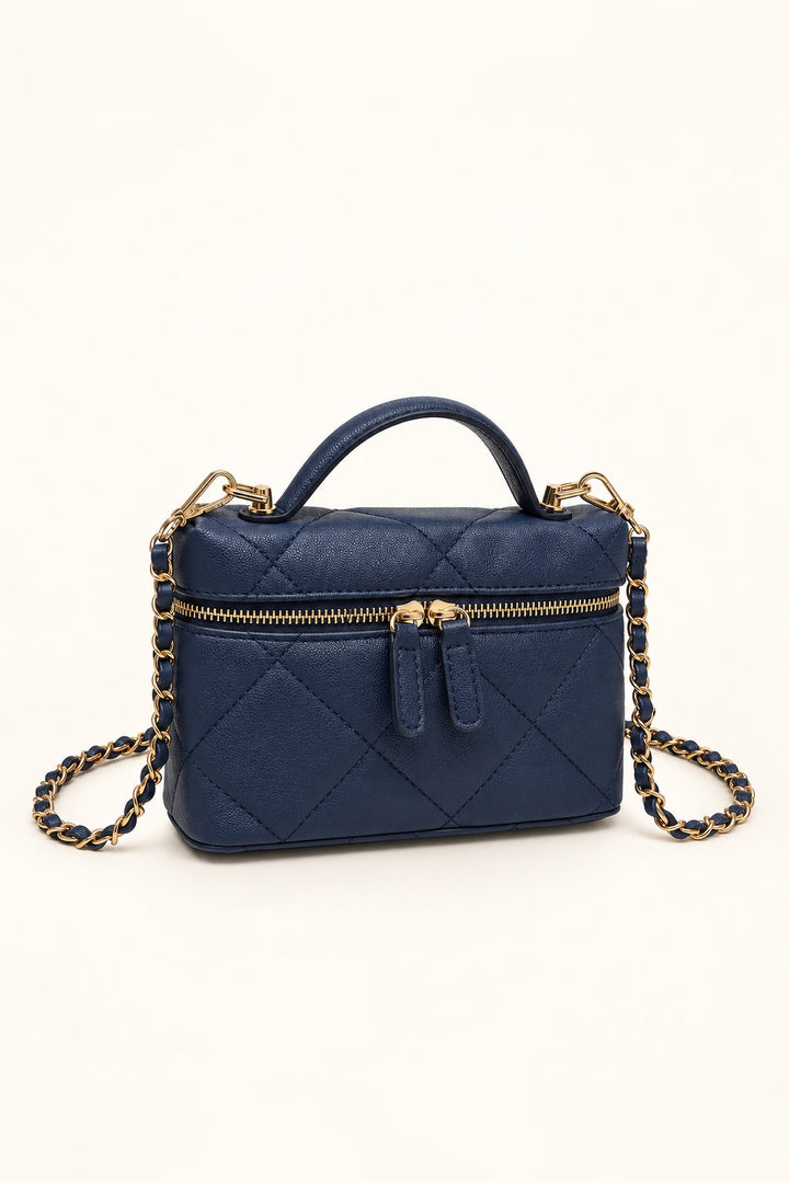 Navy quilted crossbody at an angle showing its compact structured shape